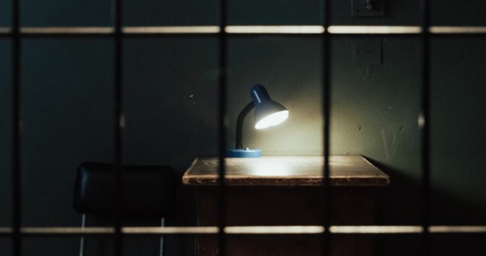 A study table in prison with the table lamp open