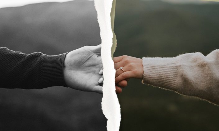 Photo of couple holding hands torn in two