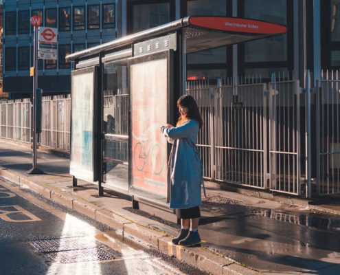 A woman is waiting for the bus