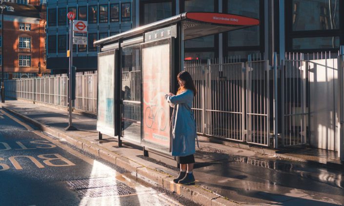A woman is waiting for the bus